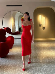 An elegant red midi dress with 3D floral appliqués, an off-shoulder neckline, and a backless design.