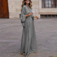 A woman wearing a stylish boho maxi dress with a pleated skirt and a relaxed fit, ideal for parties or casual wear.