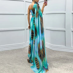 A woman wearing an elegant one-shoulder evening dress with a graphic print and a matching shawl, creating a sophisticated look.