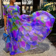 A woman twirling in an elegant bohemian maxi dress, showcasing the lightweight chiffon fabric and flattering silhouette.