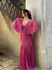 A woman twirling in a beautiful chiffon dress, showcasing its graceful movement and flattering silhouette.