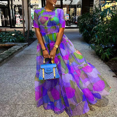 A woman twirling in an elegant bohemian maxi dress, showcasing the lightweight chiffon fabric and flattering silhouette.