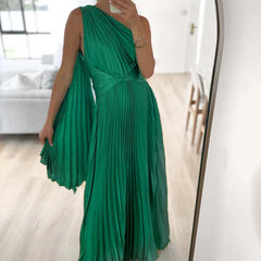 A woman wearing an elegant off-shoulder maxi dress with an oblique collar and pleated details.