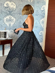 A woman wearing a sparkling sequin dress with a flowing silhouette, perfect for a night out.