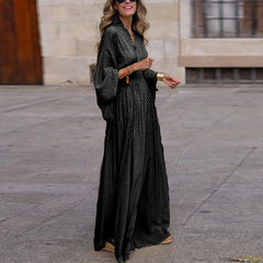 A woman wearing a stylish boho maxi dress with a pleated skirt and a relaxed fit, ideal for parties or casual wear.