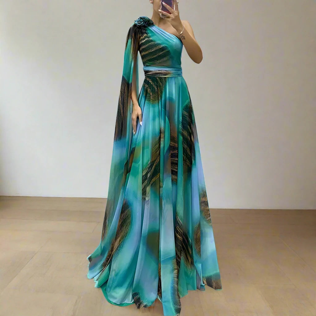 A woman wearing an elegant one-shoulder evening dress with a graphic print and a matching shawl, creating a sophisticated look.