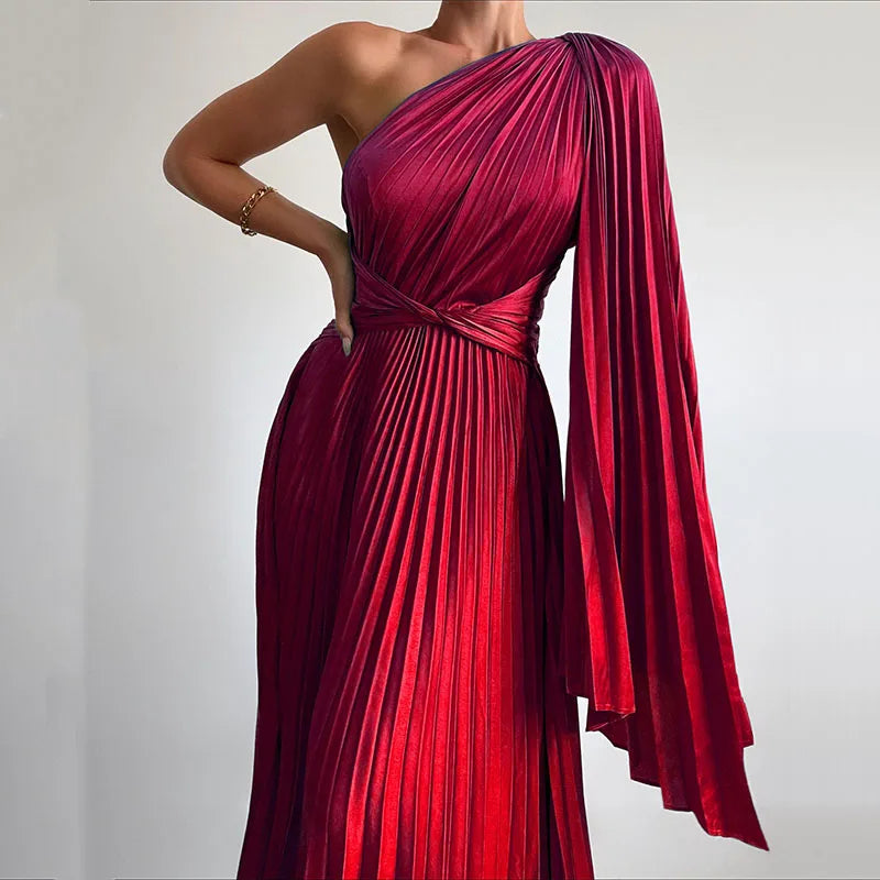 A woman wearing an elegant off-shoulder maxi dress with an oblique collar and pleated details.