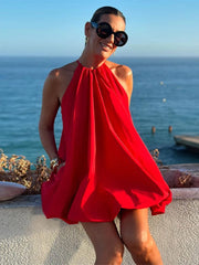 A woman twirling in a loose-fitting, red summer dress, showcasing its elegant movement and comfortable fit.